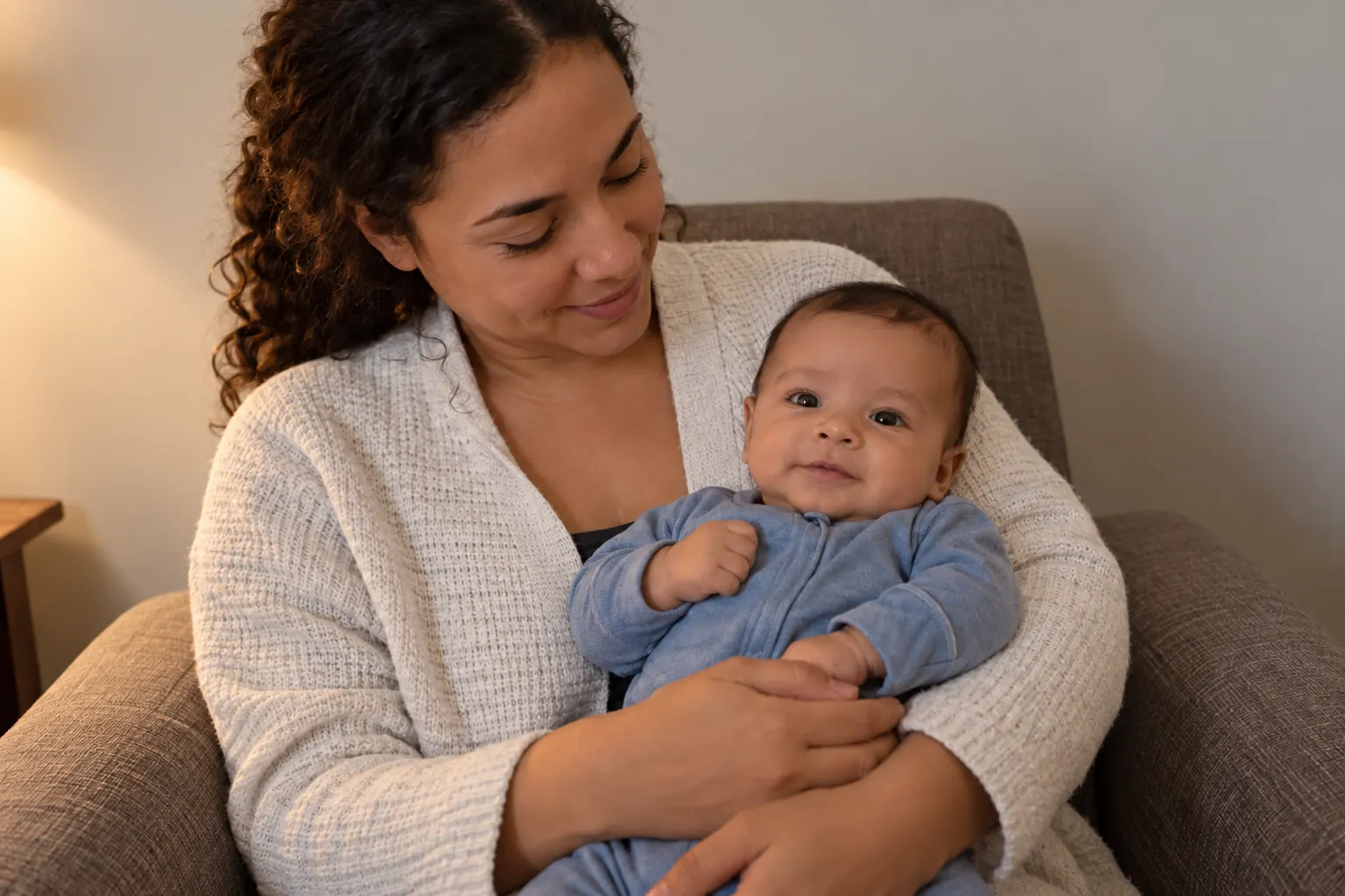 Color-corrected synthetic parent and baby photo with a neutral cardigan and more natural skin tones